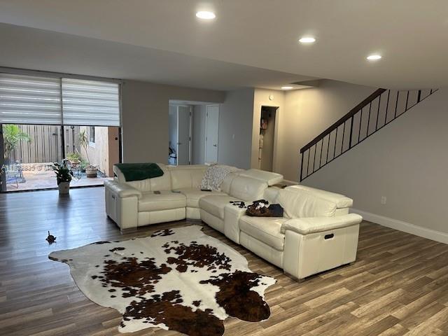 685 NE 206th Ter, Miami, FL 33179 - living room featuring wood finished floors, baseboards, recessed lighting, and stairway