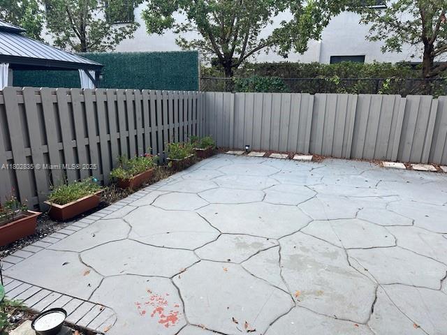 685 NE 206th Ter, Miami, FL 33179 - fenced backyard with a patio area
