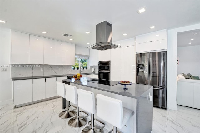 626 S 13th Ave, Hollywood, FL 33019 - kitchen featuring black appliances, island range hood, modern cabinets, light marble finish flooring, and a breakfast bar