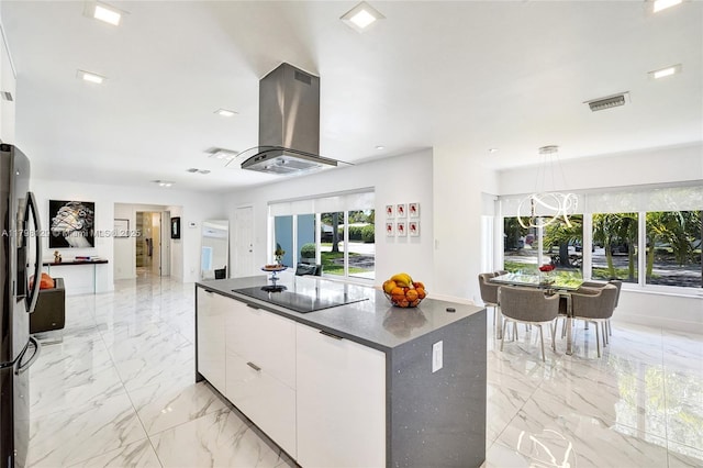 626 S 13th Ave, Hollywood, FL 33019 - kitchen featuring island range hood, dark countertops, white cabinetry, and healthy amount of natural light