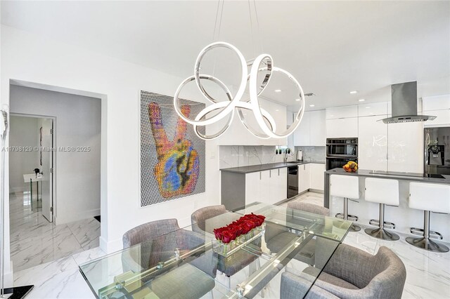 626 S 13th Ave, Hollywood, FL 33019 - dining area with light marble finish flooring, recessed lighting, and baseboards