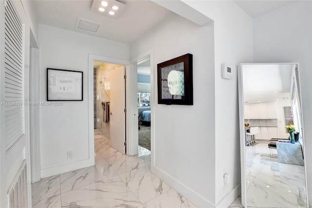 626 S 13th Ave, Hollywood, FL 33019 - hallway with baseboards, light marble finish floors, and attic access