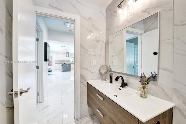 626 S 13th Ave, Hollywood, FL 33019 - bathroom featuring marble tiled floors, tile walls, and vanity