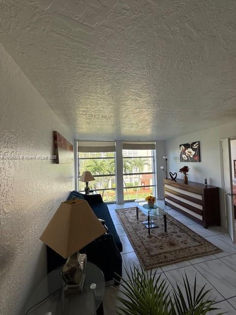 801 Three Islands Blvd Unit 302, Hallandale Beach, FL 33009 - living area with a textured ceiling and a textured wall