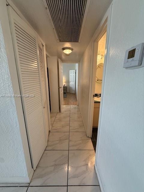 801 Three Islands Blvd Unit 302, Hallandale Beach, FL 33009 - hallway with light marble finish flooring