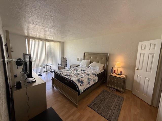 801 Three Islands Blvd Unit 302, Hallandale Beach, FL 33009 - bedroom with a textured ceiling and light wood-style flooring
