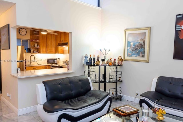 2541 Boundbrook Blvd Unit 122, Palm Springs, FL 33406 - living room featuring baseboards and a towering ceiling