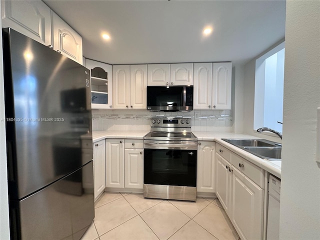 540 Brickell Key Dr Unit 302, Miami, FL 33131 - kitchen featuring appliances with stainless steel finishes, a sink, decorative backsplash, white cabinetry, and recessed lighting