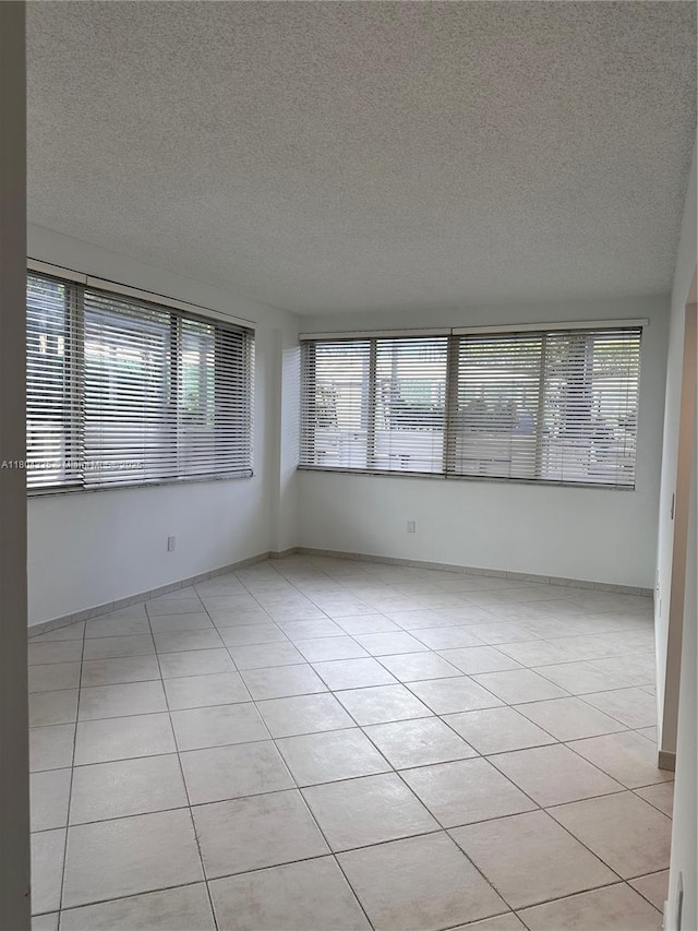 540 Brickell Key Dr Unit 302, Miami, FL 33131 - unfurnished room featuring healthy amount of natural light, a textured ceiling, and light tile patterned floors