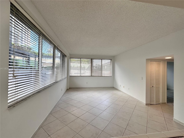 540 Brickell Key Dr Unit 302, Miami, FL 33131 - empty room with light tile patterned flooring and a textured ceiling