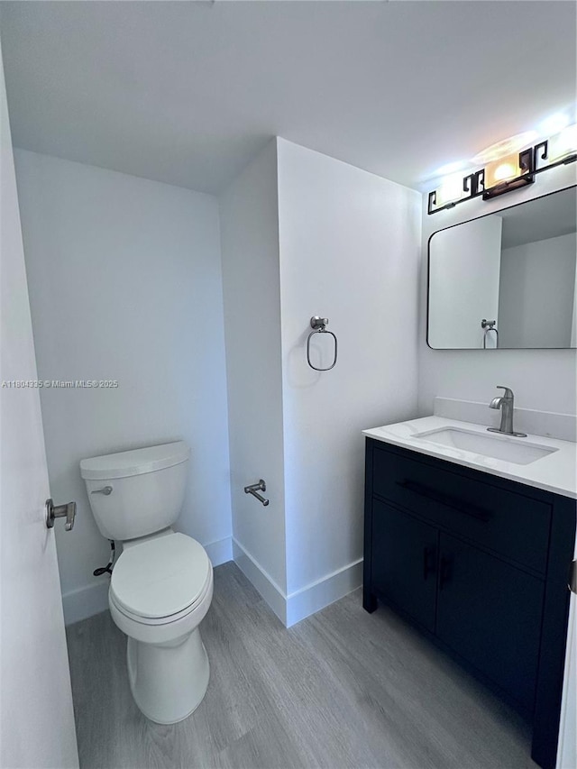 540 Brickell Key Dr Unit 302, Miami, FL 33131 - bathroom with wood finished floors, baseboards, toilet, and vanity