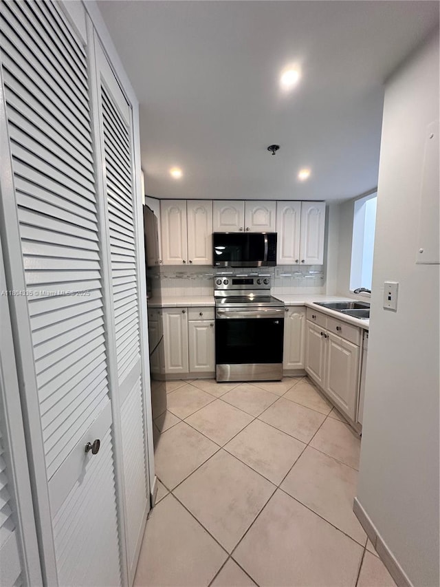 540 Brickell Key Dr Unit 302, Miami, FL 33131 - kitchen with stainless steel appliances, a sink, light countertops, backsplash, and recessed lighting