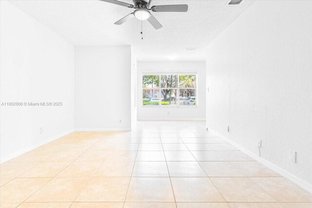 3420 N Pinewalk Dr N Unit 713, Margate, FL 33063 - empty room with a textured ceiling, a ceiling fan, light tile patterned floors, and baseboards