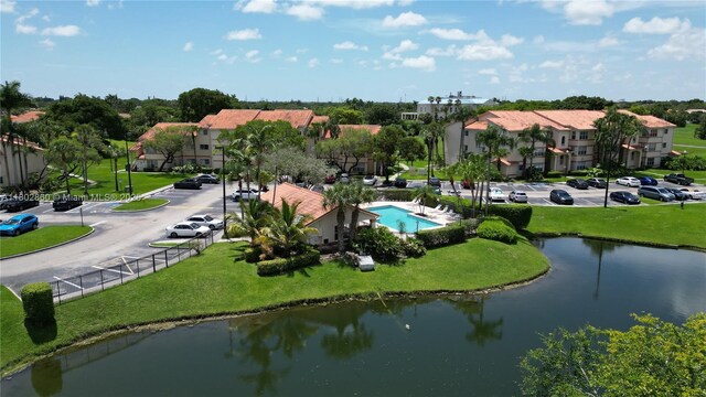 3420 N Pinewalk Dr N Unit 713, Margate, FL 33063 - drone / aerial view of a pool area and a nearby body of water