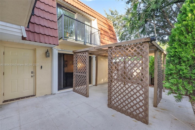 718 NW 98th Cir Unit 718, Plantation, FL 33324 - view of exterior entry with a patio, a tiled roof, and mansard roof