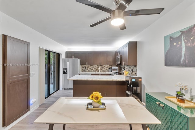 718 NW 98th Cir Unit 718, Plantation, FL 33324 - kitchen with stainless steel appliances, light wood finished floors, tasteful backsplash, a sink, and dark brown cabinetry