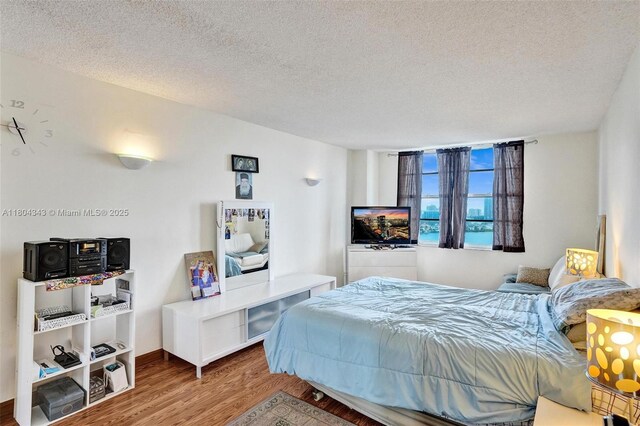 301 174th St Unit 1503, Sunny Isles Beach, FL 33160 - bedroom with wood finished floors and a textured ceiling
