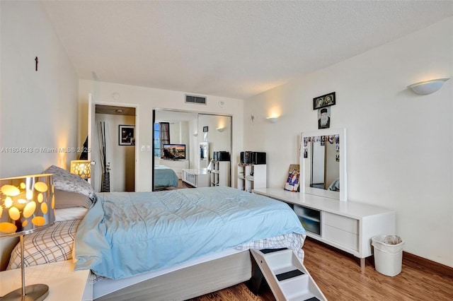 301 174th St Unit 1503, Sunny Isles Beach, FL 33160 - bedroom featuring wood finished floors, a closet, and a textured ceiling
