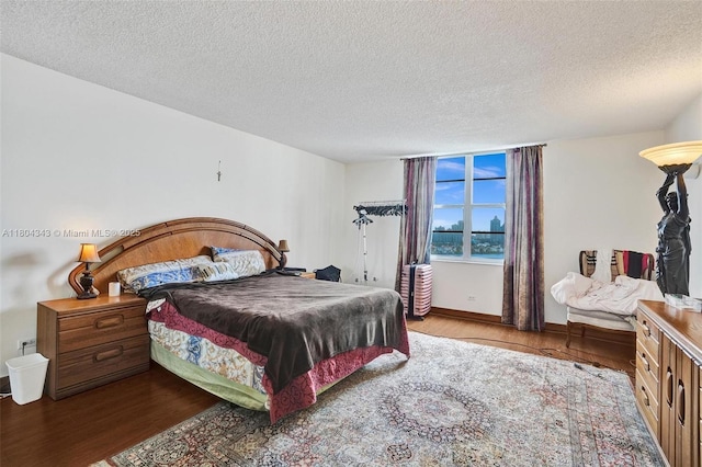 301 174th St Unit 1503, Sunny Isles Beach, FL 33160 - bedroom featuring wood finished floors, a textured ceiling, and baseboards