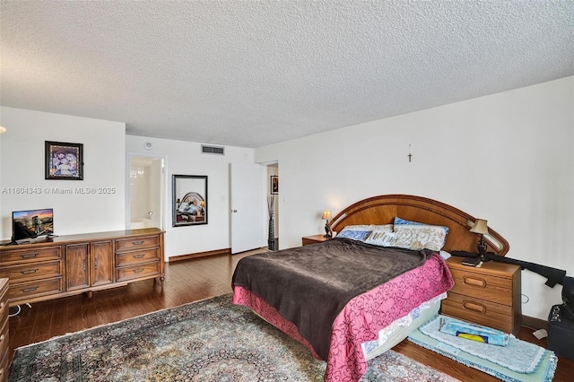 301 174th St Unit 1503, Sunny Isles Beach, FL 33160 - bedroom with dark wood finished floors, a textured ceiling, and baseboards