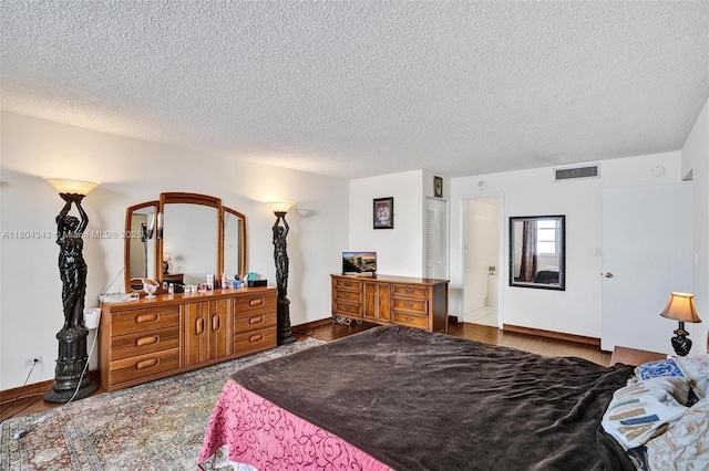 301 174th St Unit 1503, Sunny Isles Beach, FL 33160 - bedroom with a textured ceiling and baseboards