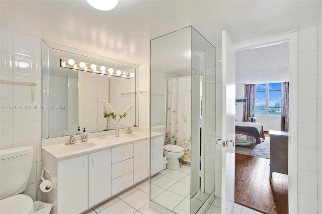 301 174th St Unit 1503, Sunny Isles Beach, FL 33160 - full bath featuring toilet, a shower with shower curtain, double vanity, ensuite bathroom, and tile patterned flooring