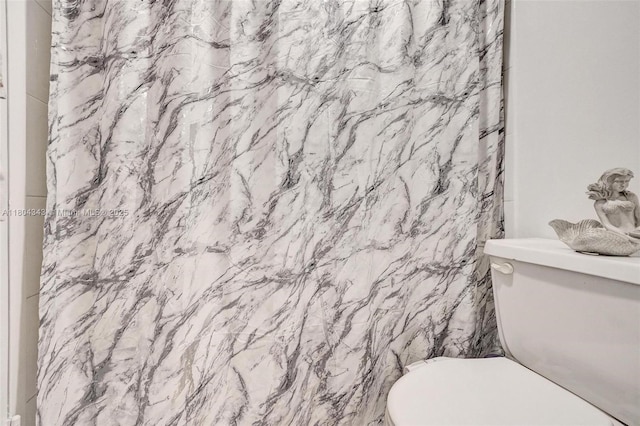 301 174th St Unit 1503, Sunny Isles Beach, FL 33160 - bathroom with toilet and a shower with shower curtain
