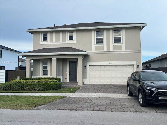 27921 SW 134th Ct, Homestead, FL 33032 - view of front of property featuring a garage, stucco siding, decorative driveway, and roof with shingles