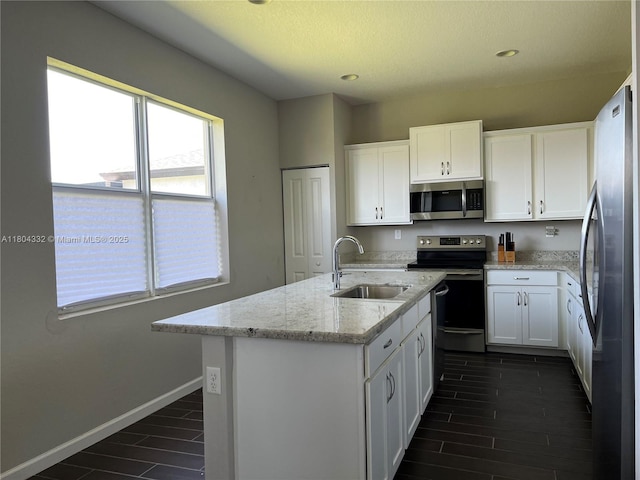 27921 SW 134th Ct, Homestead, FL 33032 - kitchen featuring appliances with stainless steel finishes, a sink, white cabinetry, wood tiled floors, and recessed lighting
