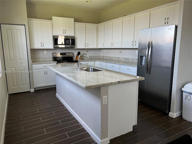 27921 SW 134th Ct, Homestead, FL 33032 - kitchen with appliances with stainless steel finishes, a sink, wood finish floors, and white cabinets