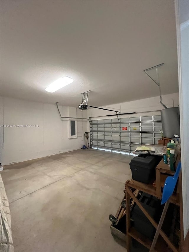 27921 SW 134th Ct, Homestead, FL 33032 - garage featuring water heater and a garage door opener