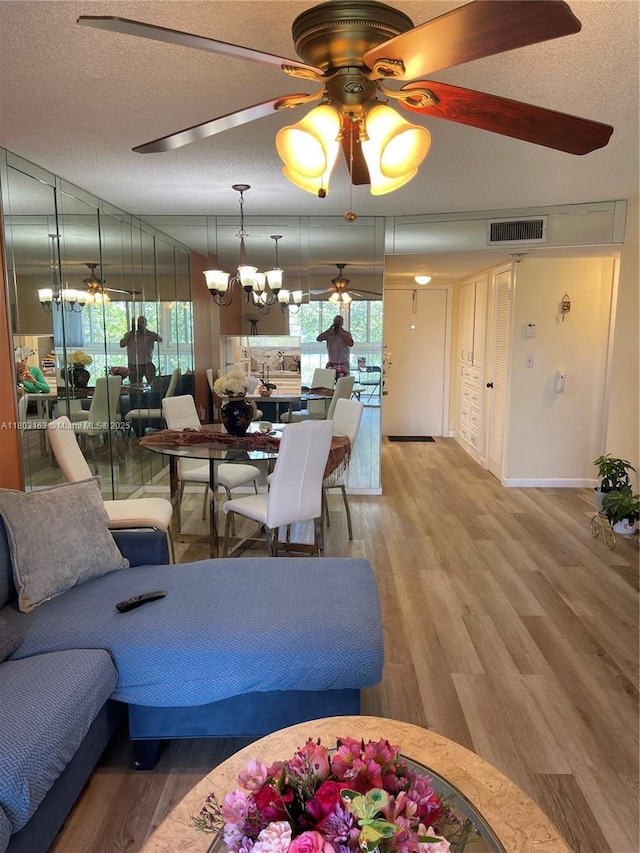 2911 N Pine Island Rd Unit 311, Sunrise, FL 33322 - living area featuring ceiling fan, a textured ceiling, and light wood-style flooring