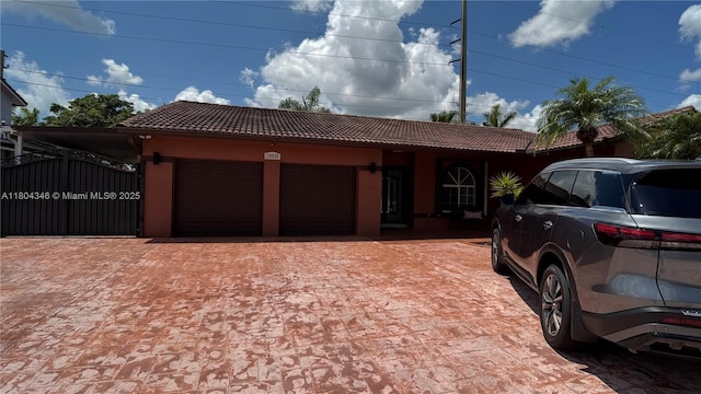 14620 SW 151st Ter, Miami, FL 33186 - view of front of home with a tile roof, a garage, stucco siding, and decorative driveway