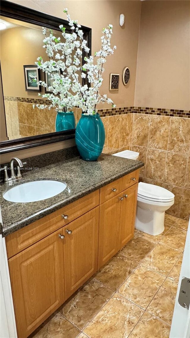 14620 SW 151st Ter, Miami, FL 33186 - bathroom featuring tile walls, vanity, toilet, and a wainscoted wall