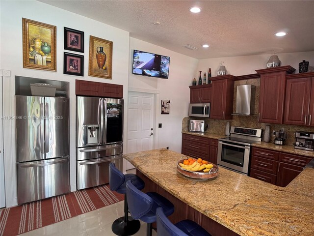14620 SW 151st Ter, Miami, FL 33186 - kitchen featuring stainless steel appliances, wall chimney exhaust hood, tasteful backsplash, a textured ceiling, and recessed lighting
