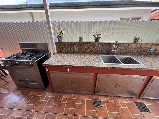14620 SW 151st Ter, Miami, FL 33186 - kitchen with range with gas stovetop, a sink, and brick patterned flooring