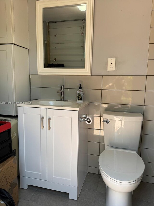 14620 SW 151st Ter, Miami, FL 33186 - half bathroom with tile patterned floors, vanity, tile walls, and toilet