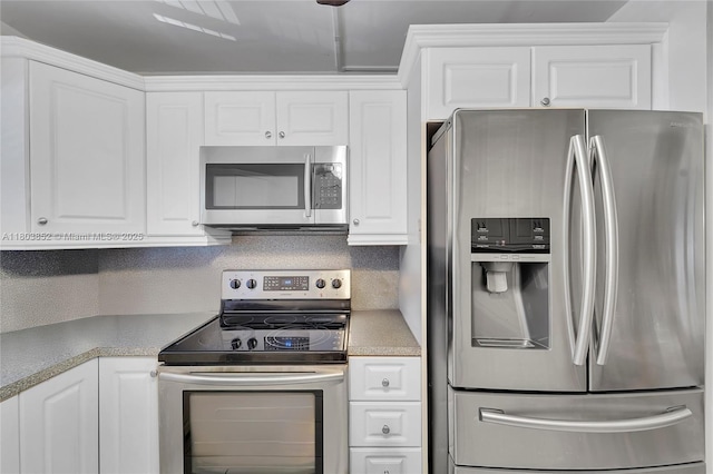 9781 Sunrise Lakes Blvd Unit 202, Sunrise, FL 33322 - kitchen featuring stainless steel appliances, light countertops, and white cabinets