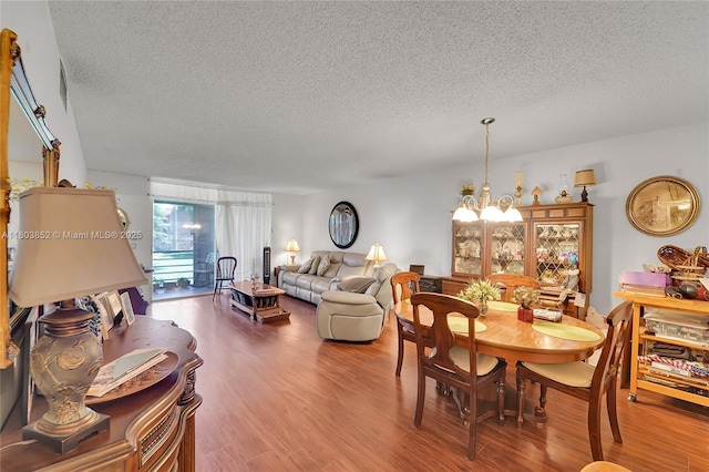 9781 Sunrise Lakes Blvd Unit 202, Sunrise, FL 33322 - dining area with a textured ceiling, a chandelier, and wood finished floors