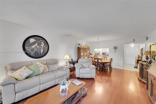 9781 Sunrise Lakes Blvd Unit 202, Sunrise, FL 33322 - living area with a textured ceiling, a chandelier, and light wood finished floors