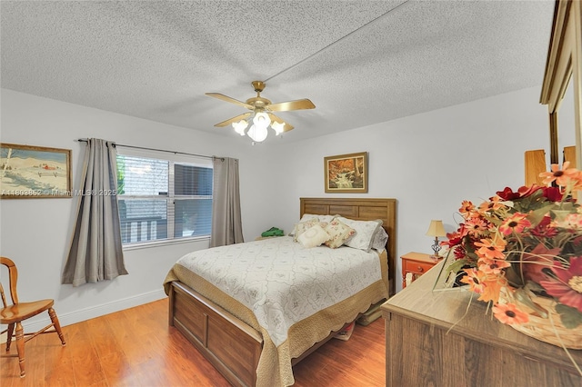 9781 Sunrise Lakes Blvd Unit 202, Sunrise, FL 33322 - bedroom featuring light wood-style flooring, a textured ceiling, and a ceiling fan