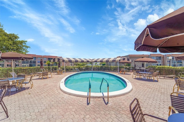 9781 Sunrise Lakes Blvd Unit 202, Sunrise, FL 33322 - community pool featuring a residential view and a patio