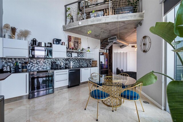 690 SW 1st Ct Unit Phi26, Miami, FL 33130 - kitchen featuring stainless steel appliances, backsplash, dark countertops, white cabinets, and open shelves