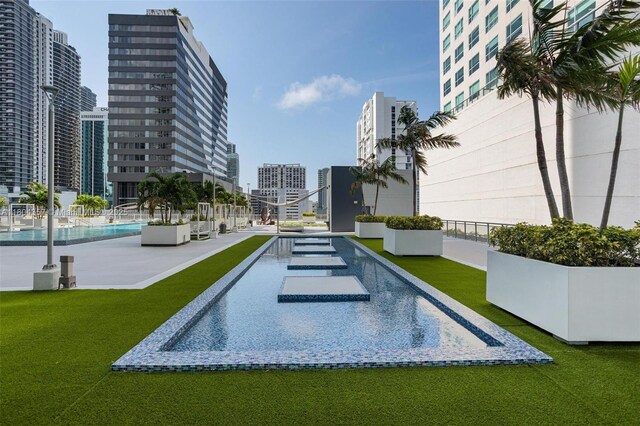 690 SW 1st Ct Unit Phi26, Miami, FL 33130 - view of swimming pool featuring a city view and a lawn