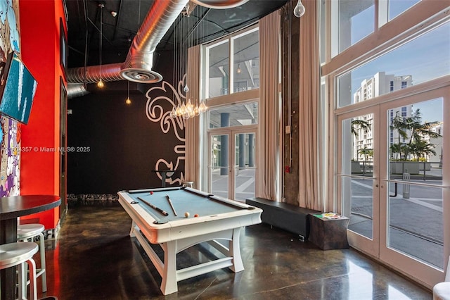 690 SW 1st Ct Unit Phi26, Miami, FL 33130 - game room featuring french doors, a high ceiling, concrete flooring, plenty of natural light, and billiards