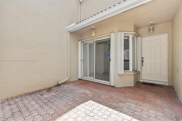 view of exterior entry with stucco siding