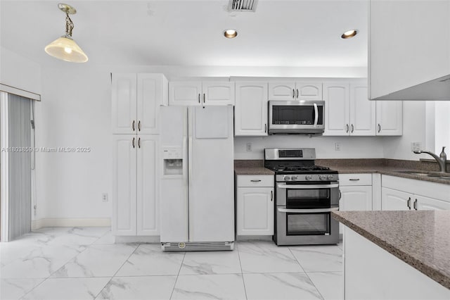 kitchen featuring appliances with stainless steel finishes, a sink, light marble finish flooring, white cabinets, and recessed lighting