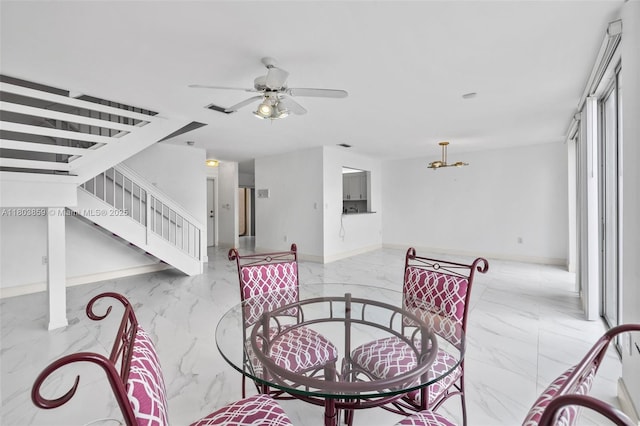 dining room featuring marble tiled floors, stairway, and a ceiling fan