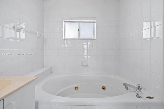 full bath with a jetted tub and vanity