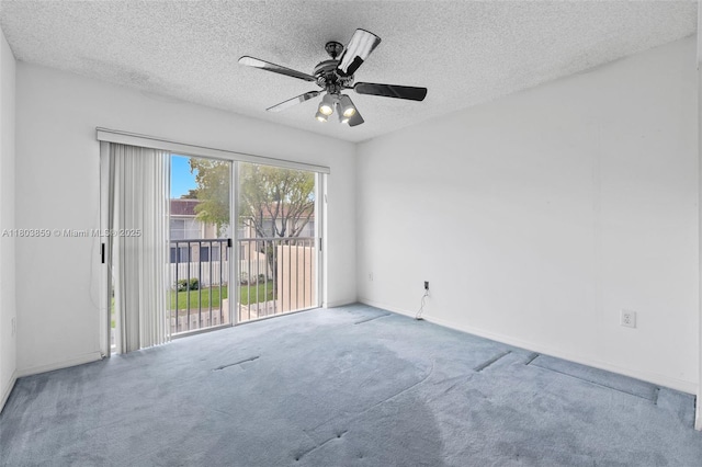 carpeted empty room with a textured ceiling, ceiling fan, and baseboards